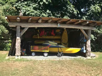 a shelter with a yellow kayak under it at Saratoga beach cabin with hot tub in Oyster Bay