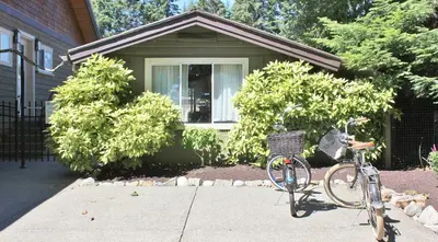 a bike parked in front of a house at Saratoga beach cabin with hot tub in Oyster Bay