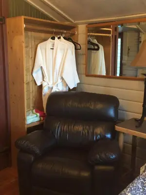 a leather reclining chair in a room with a mirror at Saratoga beach cabin with hot tub in Oyster Bay