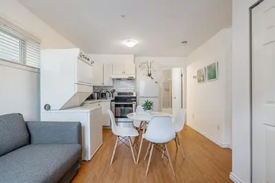 a kitchen and living room with a table and chairs at Private Guest Suite with Kitchen in Vancouver