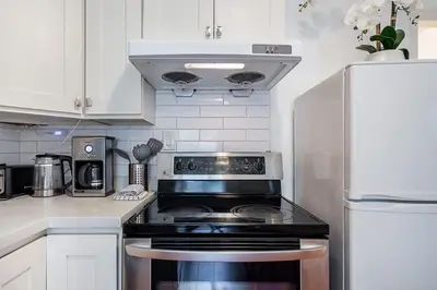 a kitchen with a stove and a refrigerator at Private Guest Suite with Kitchen in Vancouver