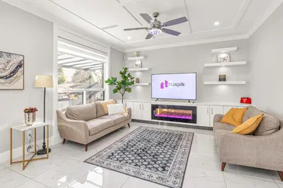 a living room with two couches and a flat screen tv at 8BR New Spacious Home White Rock HVAC Free Parking in Surrey