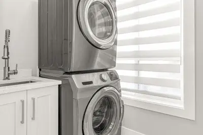 a washing machine and a dryer in a kitchen at 8BR New Spacious Home White Rock HVAC Free Parking in Surrey