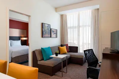 a hotel room with a couch and a bed at Residence Inn by Marriott Calgary South in Calgary