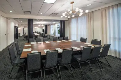 a conference room with a large wooden table and chairs at Residence Inn by Marriott Calgary South in Calgary