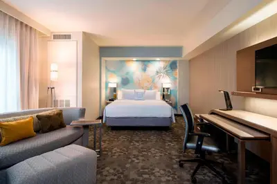 a hotel room with a bed and a desk at Courtyard by Marriott Calgary South in Calgary