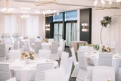 a banquet hall with white tables and chairs at Courtyard by Marriott Calgary South in Calgary