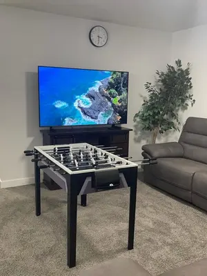 a living room with a chess table and a television at Exquisite 4BR & 3 Baths 2000sqft Home in Calgary