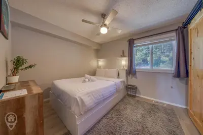 a bedroom with a bed with a ceiling fan and a window at InnWest by StayIn in Kimberley