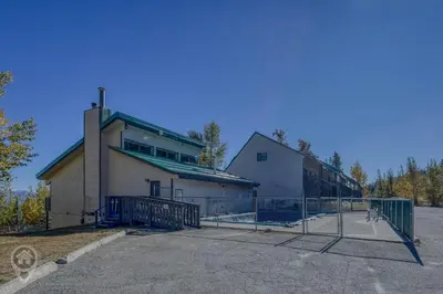 a building with a fence in front of it at InnWest by StayIn in Kimberley