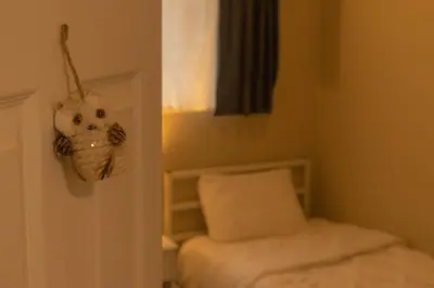 a room with a bed and a door with a w basket at Mi Light House \u7c73\u62c9 in Yellowknife