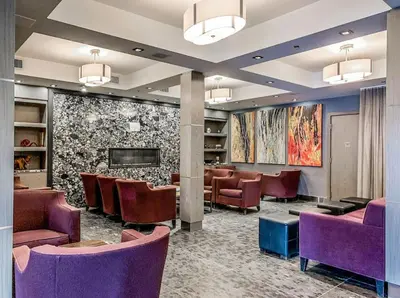 a waiting room at a hospital with purple chairs at 2BR Scenic Rockies Retreat BBQ Hot Tub and Pool in Canmore