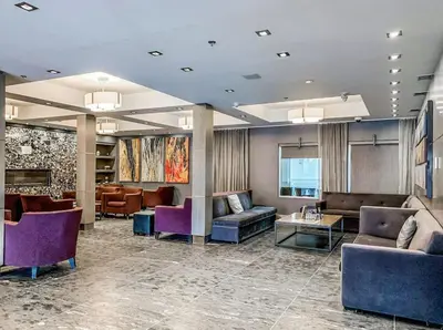 a hotel lobby with couches and tables and chairs at 2BR Scenic Rockies Retreat BBQ Hot Tub and Pool in Canmore