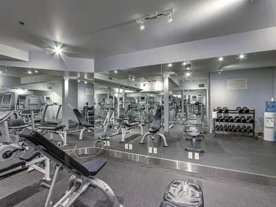 a gym with a lot of treadmills and machines at 2BR Scenic Rockies Retreat BBQ Hot Tub and Pool in Canmore
