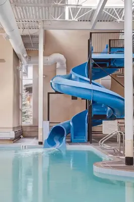 a water slide in a swimming pool at LUXUS 4BR Penthouse 2500sqft with Private Hot Tub in Canmore
