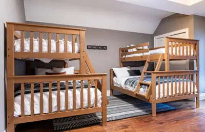 a bedroom with two bunk beds and a crib at LUXUS 4BR Penthouse 2500sqft with Private Hot Tub in Canmore