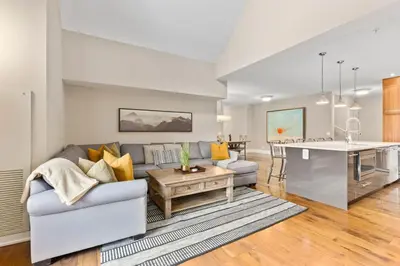 a living room with a couch and a table at LUXUS 4BR Penthouse 2500sqft with Private Hot Tub in Canmore