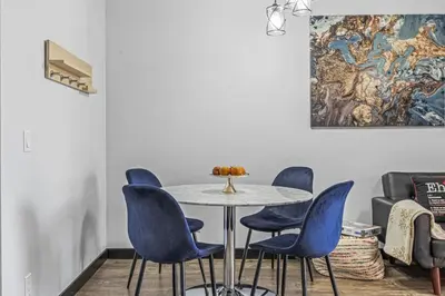 a dining room with a table and blue chairs at Perfect Rockies Escape with Pool, Hot Tub and Gym in Canmore
