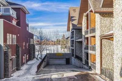 an alleyway between two buildings with snow on the ground at Perfect Rockies Escape with Pool, Hot Tub and Gym in Canmore