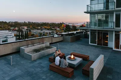 a group of people sitting on a patio on a building at Downtown Calgary Modern 1BR with Pullout couch in Calgary