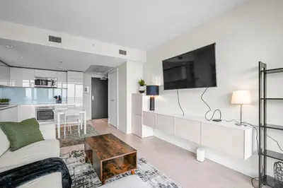 a living room with a couch and a tv at Downtown Calgary Modern 1BR with Pullout couch in Calgary