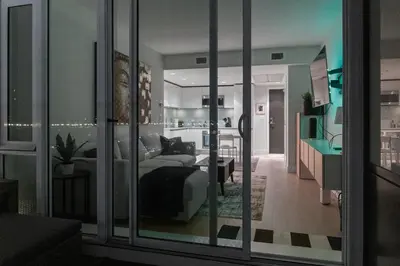 a room with a bed and a living room at Downtown Calgary Modern 1BR with Pullout couch in Calgary