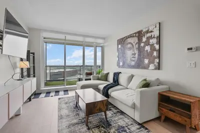 a living room with a couch and a table at Downtown Calgary Modern 1BR with Pullout couch in Calgary