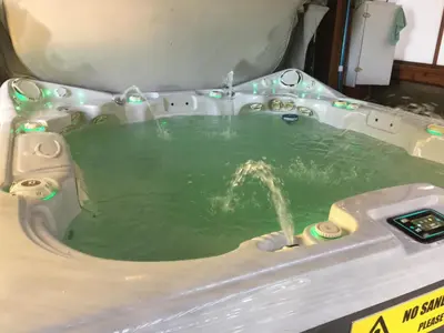 a pool of green water in a machine at The Wood Shed with hot tub in Oyster Bay