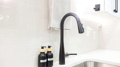 a kitchen sink with two bottles of wine at A true Home away from Home in Calgary