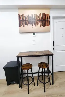 a table and two stools in a room at A true Home away from Home in Calgary