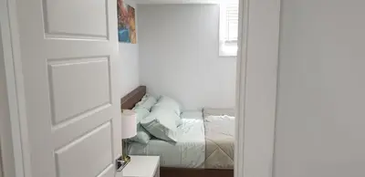 a door leading to a bedroom with a bed at Executive 1Bedroom Suite By Henday in Edmonton