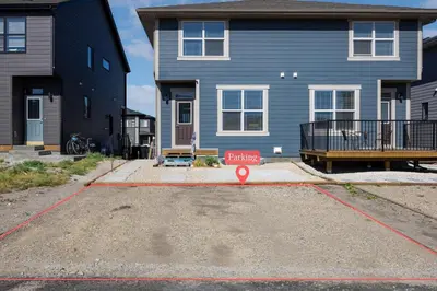 a blue house with a sign in front of it at Brand New Private Secondary Suite in Mahogany in Calgary