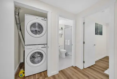 a white laundry room with a washer and dryer at Brand New Private Secondary Suite in Mahogany in Calgary