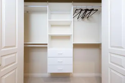 a closet with white cabinets and a door at Prime Richmond Stay 10 min to YVR & Steveston in Richmond