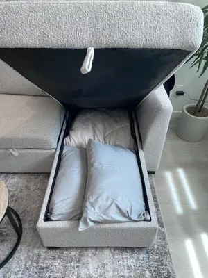 a couch with a pillow sitting inside of it at YYC Retreat - Near Mountains & Airport in Calgary
