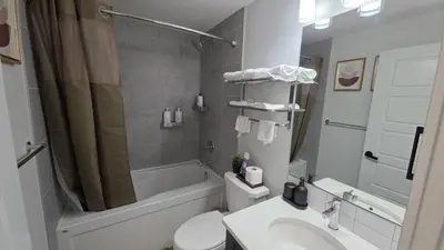 a bathroom with a toilet and a shower and a sink at Modern 2BR Suite in Seton, Calgary in Calgary