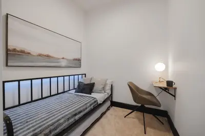 a bedroom with a bed and a picture on the wall at Walk University District, Near Hospitals & Shops in Calgary
