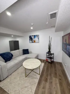 a living room with a couch and a table at Serenity Suite 3603 in Edmonton