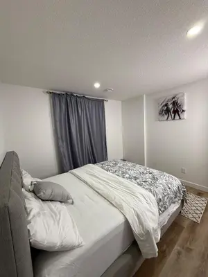a bedroom with a bed and a window at Serenity Suite 3603 in Edmonton