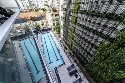 an overhead view of two swimming pools in a city at Corporate Stays Telus Gardens 1 Bedroom in Vancouver