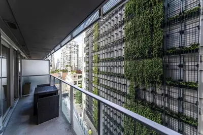 a balcony with a green wall on a building at Corporate Stays Telus Gardens 1 Bedroom in Vancouver