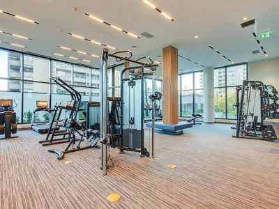 a gym with treadmills and ellipticals in a building at Corporate Stays Hazel 1 Bedroom in Burnaby