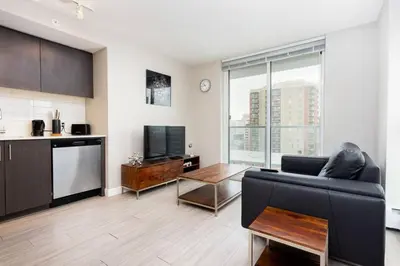 a living room with a couch and a tv at Corporate Stays Hendrix - 2 Bedrooms in Edmonton