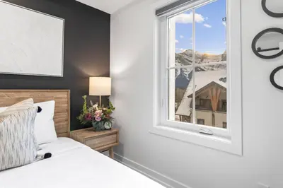 a bedroom with a bed and a window at 3BR Mountain Bliss Retreat with Gym Hot Tub and Sauna in Canmore