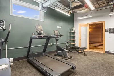 a gym with two exercise bikes in a room at 3BR Mountain Bliss Retreat with Gym Hot Tub and Sauna in Canmore