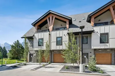 a large house with a garage at 4BR Golden Ridge Mountain Escape with Hot Tub and Gym in Canmore