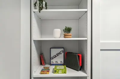a closet with a shelf with items on it at 4BR Golden Ridge Mountain Escape with Hot Tub and Gym in Canmore