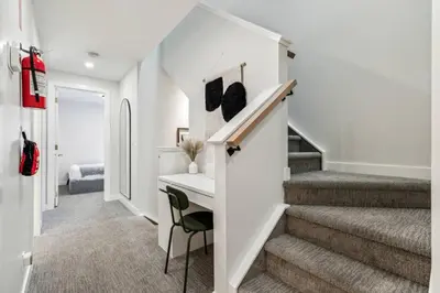 a home office with a desk and stairs in a hallway at 4BR Golden Ridge Mountain Escape with Hot Tub and Gym in Canmore