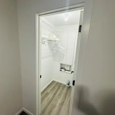 a hallway with a door leading into a room at Modern Basement Suite near West Edmonton Mall in Edmonton