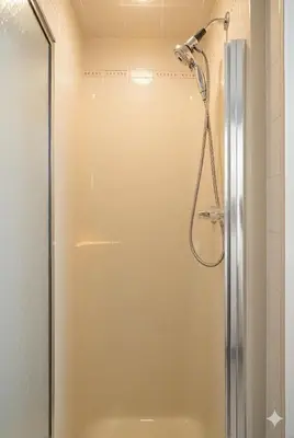 a shower with a glass door in a bathroom at Family Friendly Welcoming Basement Suite in Calgary